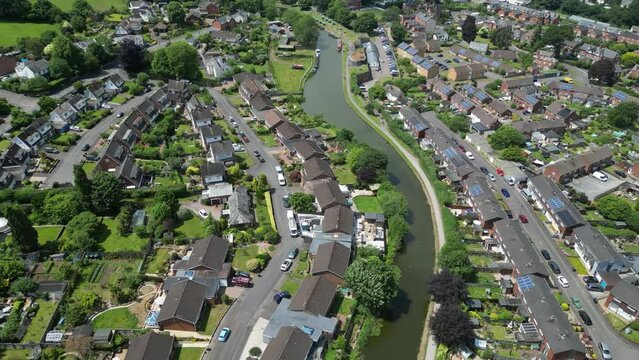 Tiverton, Devon, England: DRONE VIEWS: The Grand Western Canal cuts through suburban housing. The canal features horse-drawn barges which are a popular tourist attraction (Clip 2).