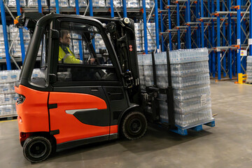 Forklift operator driving the forklift carrying the load in the warehouse © Eomer2010