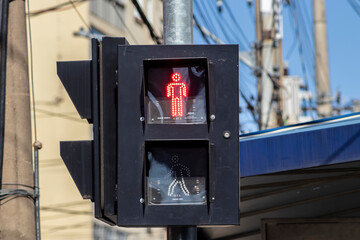 Red stop traffic light, for pedestrians on the street in downtown of the city in Brazil