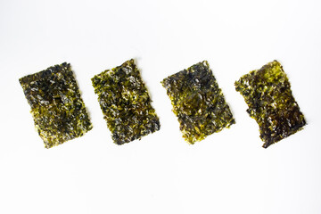 korean roasted crispy nori seaweed snack isolated on white © Zakiavida