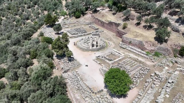 Aerial bird's eye view video taken by drone of archaeological site of ancient Delphi, site of temple of Apollo and the Oracle, Voiotia, Greece