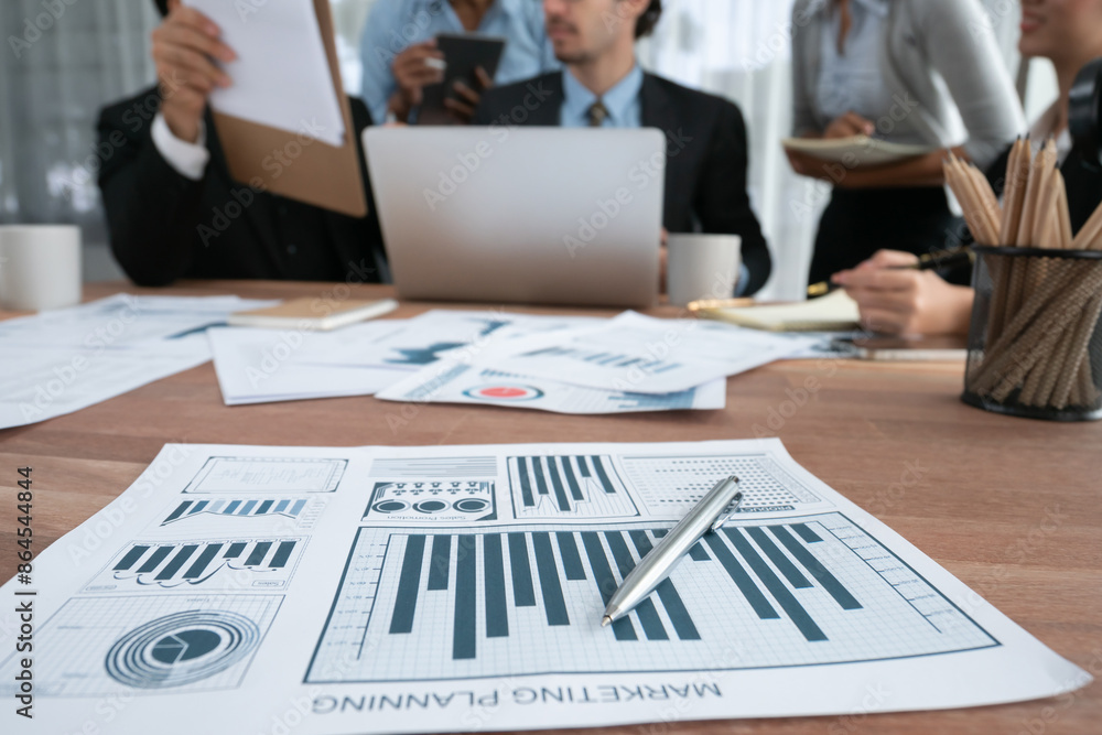 Aufkleber piles of analyzed financial data dashboard on meeting table with background of business people analy