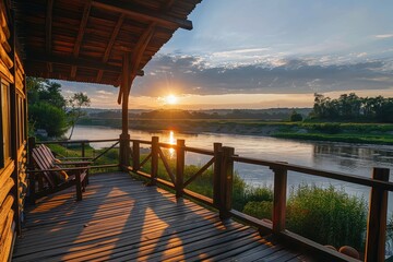 Sunrise over a tranquil river captured from a wooden deck, forming an enchanting landscape where the morning light dances on the water surface beneath the half-clouded sky.