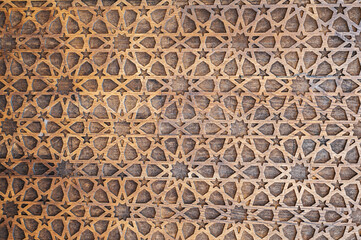 Uzbek Islamic patterns ornament with stars on a modern wooden carved door in Uzbekistan close-up