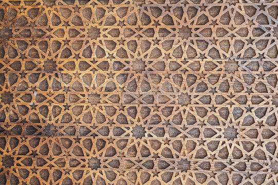 Uzbek Islamic patterns ornament with stars on a modern wooden carved door in Uzbekistan close-up
