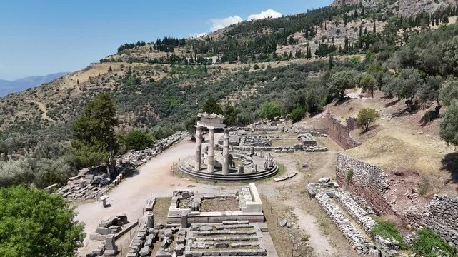 Aerial bird's eye view video taken by drone of archaeological site of ancient Delphi, site of temple of Apollo and the Oracle, Voiotia, Greece