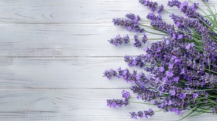 Fototapeta premium Fresh flowers of lavender bouquet top view on white wooden background