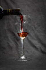 red wine pouring into glass