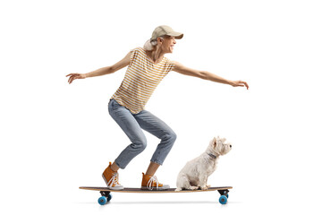 Cheerful young riding a longboard with a dog