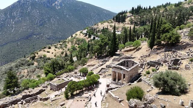 Aerial bird's eye view video taken by drone of archaeological site of ancient Delphi, site of temple of Apollo and the Oracle, Voiotia, Greece