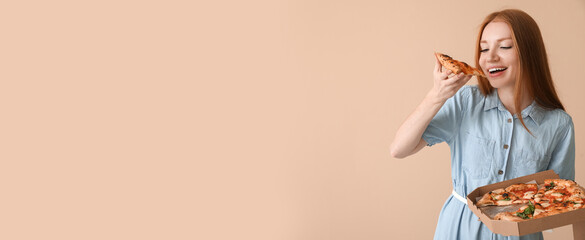 Young woman eating tasty pizza on beige background