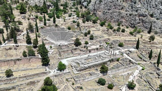 Aerial bird's eye view video taken by drone of archaeological site of ancient Delphi, site of temple of Apollo and the Oracle, Voiotia, Greece