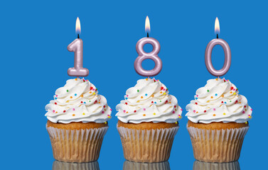 Birthday Cupcakes With Candles Lit Forming The Number 180