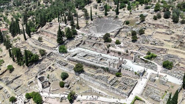 Aerial bird's eye view video taken by drone of archaeological site of ancient Delphi, site of temple of Apollo and the Oracle, Voiotia, Greece