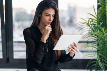 Smart freelance business woman seller working with digital tablet in her startup small business.