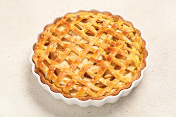 Baking dish with delicious apple pie on white background