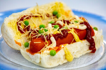 Traditional Brazilian style hot dog with sausage, peas and straw potatoes