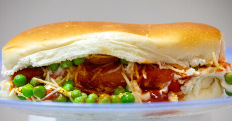 Traditional Brazilian style hot dog with sausage, peas and straw potatoes