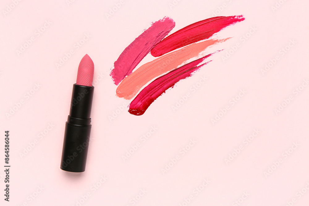 Wall mural Beautiful lipstick with different strokes on pink background