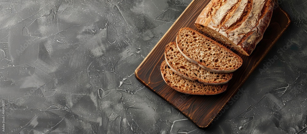 Poster flat lay of wholemeal rye bread slices on a cutting board with copy space image.