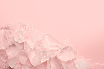 Pieces of crushed ice on pink background, top view. Space for text