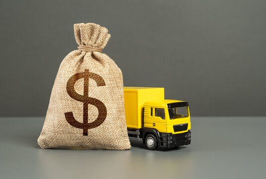 Cargo delivery truck and dollar money bag. Loan or deposit. Financial aid, investments and subsidies. High super income. Payment of taxes. Debt load. Money transfers and transactions. Compensation.