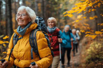 Senior hikers in autumn forest. Elderly women enjoying outdoor activity and exercise in a beautiful fall setting. Ideal for promoting active lifestyles and senior well-being in travel