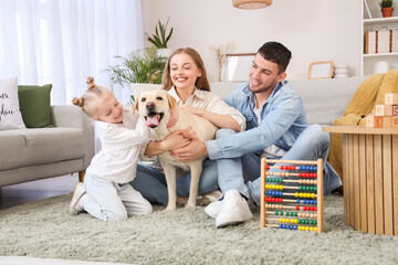 Happy family with Labrador dog at home