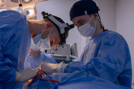 A surgical team is carrying out an operation in the operating room of a hospital