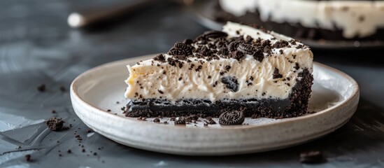 Enjoying a slice of Oreo cheesecake on a plate with visible copy space image.