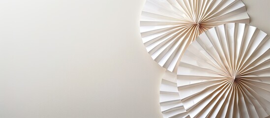 Elegant white paper fans arranged in a simple oriental style against a soft light background, ideal for a copy space image.