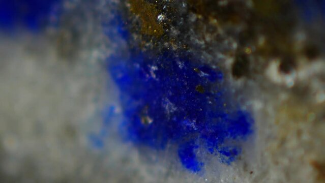 Lapis Lazuli under microscope: (Na,Ca)8(AlSiO4)6(SO4,S,Cl)2, deep blue with gold flecks, prized since ancient times. Mohs hardness 5-6. Contains lazurite, calcite, pyrite. Valued for beauty, spiritual