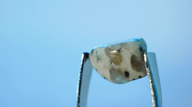 Kiwi Stone (Kiwi Jasper or Sesame Jasper, SiO2), light green stone with black and clear specks. It symbolizes tranquility and nurturing. Hardness 6.5-7 on Mohs. Composed of chalcedony quartz