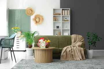 Obraz premium Interior of festive living room with green sofa and decorations for Festa Junina celebration
