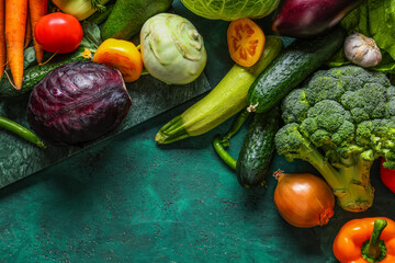 Different fresh vegetables on green background