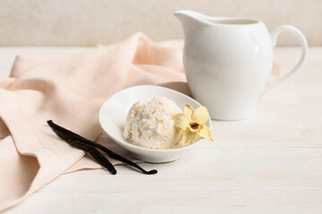 Napkin, jug and bowl with vanilla ice cream on white table