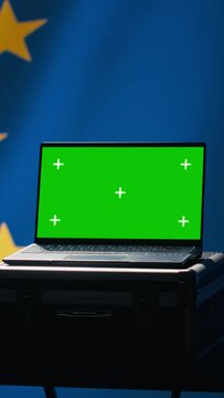 Vertical video EU alliance engineer uses green screen laptop to protect against fake accounts on social media. Technician doing cybersecurity job for European Union with mockup notebook, camera A