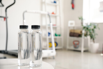 Bottles of water on table in gym, closeup