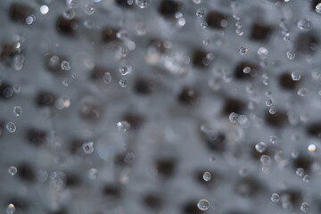 Macro shot of water droplet flowing from head shower