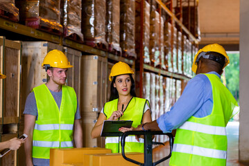 Group of man and woman warehouse worker meeting and discussion during working and checking inventory stock in distribution fulfillment center. Freight transportation logistic cargo business concept.
