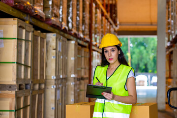 Caucasian woman warehouse worker employee working and checking inventory stock on parcel shelf in distribution fulfillment center. Business industry and freight transportation logistic cargo concept.