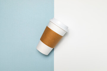Paper Coffee or Tea Mug, Cup with White Lid and Corrugated Sleeve On White and Blue Background. Eco Hot Drinks Cup, Beverage, Horizontal Plane, Copy Space. On the Go Food Service Application