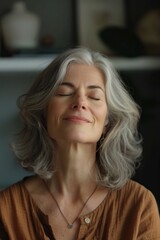 Fototapeta premium A woman lying down with her eyes shut, possibly meditating or sleeping