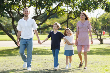 Caucasian white people family relaxing together at park.