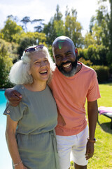 Embracing and smiling, senior friends enjoying time together outdoors