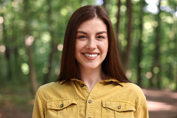 Portrait of smiling woman in forest. Spring vibes