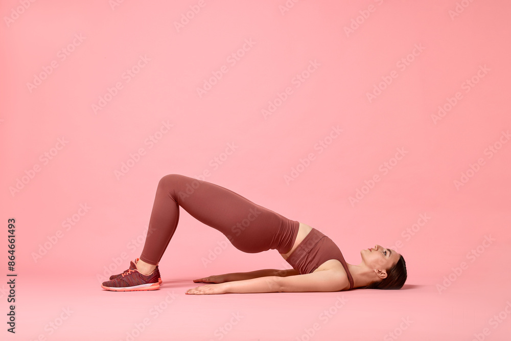 Sticker Young woman doing aerobic exercise on pink background