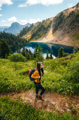 Female hiker with backpack looks into the distance. Mount Winchester Trail near Twin lakes in North...