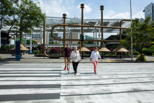 Senior tourists at the famous Jairo Varela Square. Senior travel concept. Senior people crossing the road using the crosswalk. Road safety. Pedestrian road safety
