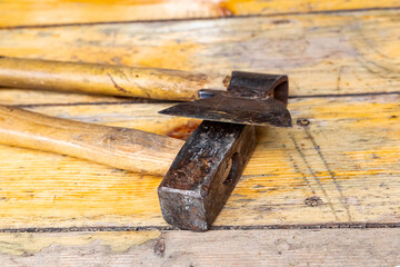 house construction arbors tool ax hammer heavy weathered metal head on wooden background